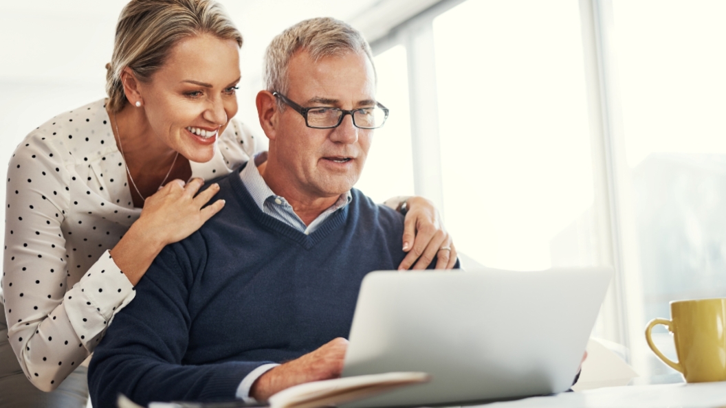 Couple looking at computer, analyzing retirement spending with inflation