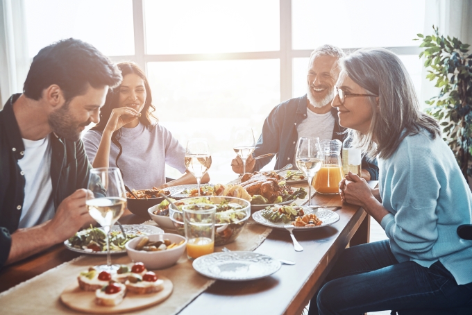 7.22 CC Photo Multigenerational family having a conversation and laughing over a meal